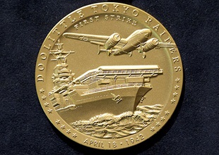 The front of the Doolittle Tokyo Raiders’ Congressional Gold Medal features the first B-25 taking off from the USS Hornet; the words, “First Strike”; the date of the raid, and 16 stars representing each B-25 crew. Photo courtesy of the National Museum of the U.S. Air Force.